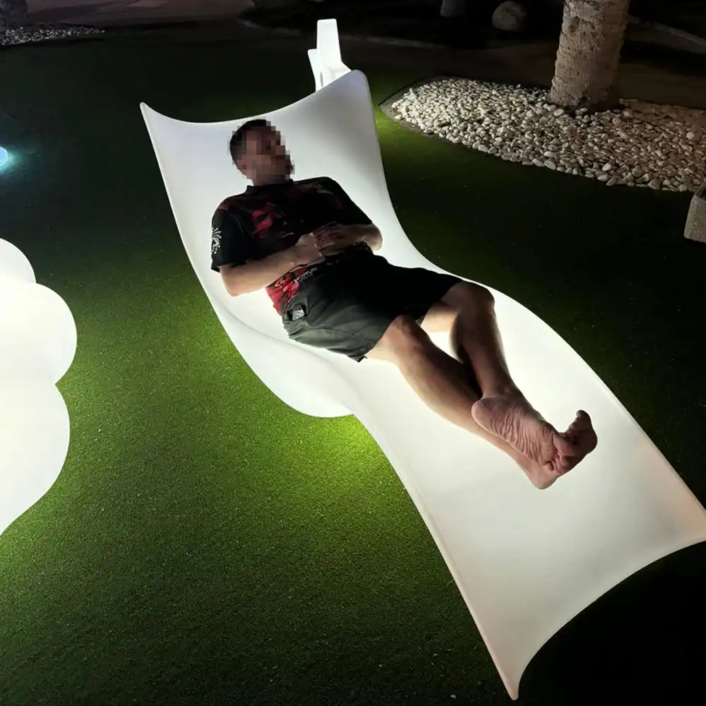 Man-Reclining-on-a-Glowing-Outdoor-Lounge-Chair-Under-the-Night-Sky