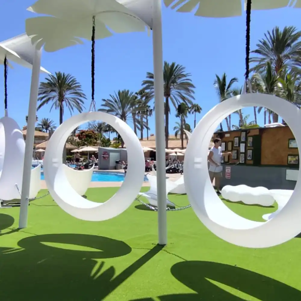 Modern-Outdoor-Space-with-White-Circular-Swings-Tropical-Pool-and-Tropical-Architecture-in-a-Resort-Setting