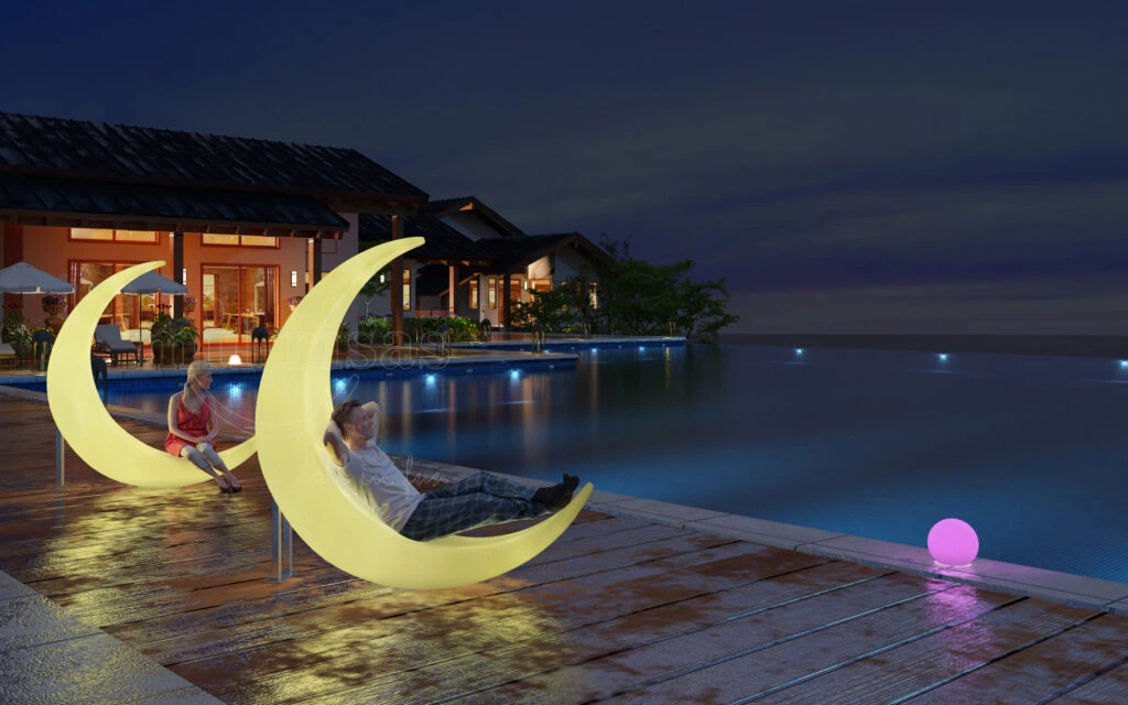 Dreamy LED moon floor light hanging chairs and glow globe lights illuminating a luxury resort swimming pool deck at night.