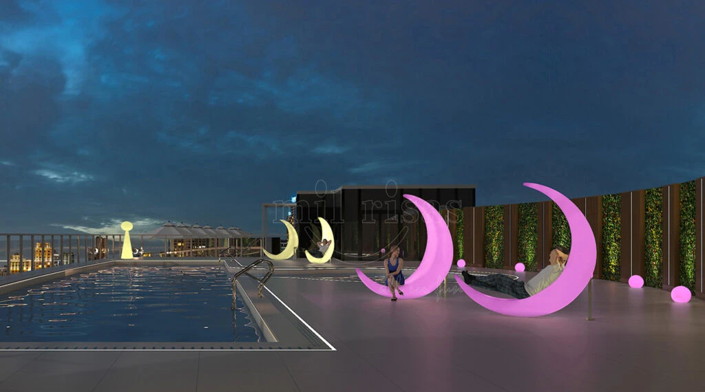 Modern hotel rooftop infinity pool lounge featuring pink and yellow LED half moon swing chairs at night