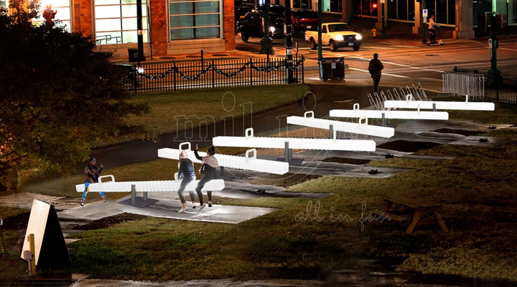 Adults Socializing And Having Fun On Outdoor Teeter-Totters