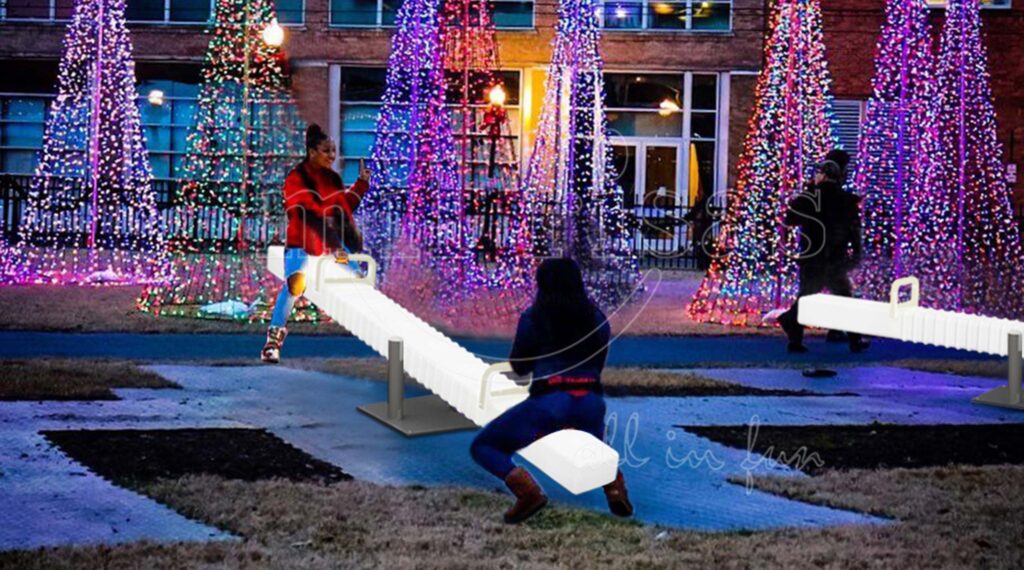 Adults Enjoying a Backyard Seesaw with Glowing Furniture at Night