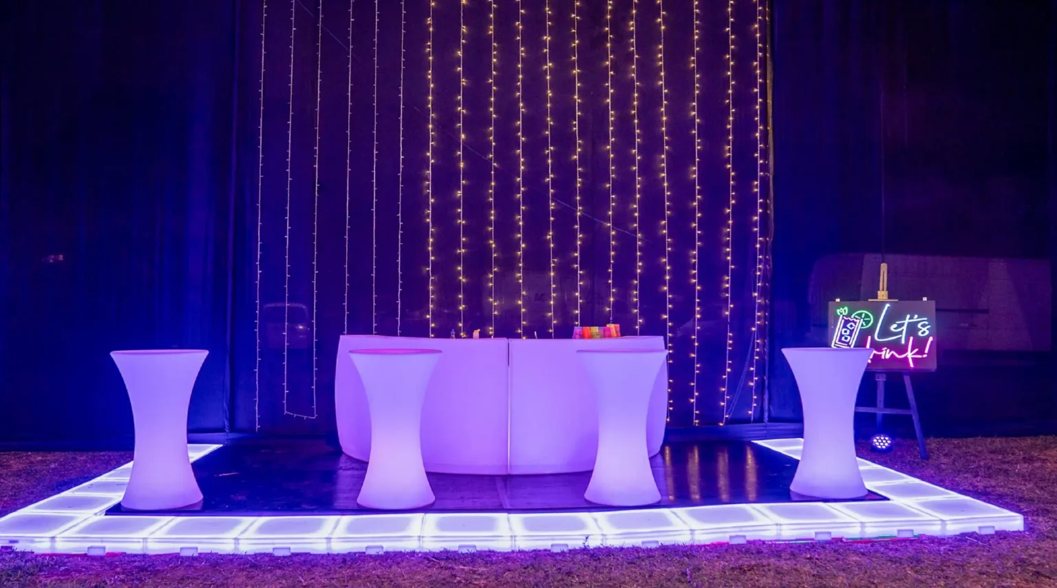 Glowing Bar with High Tables and LED Glow Party Furniture, Surrounded by Decorative String Lights