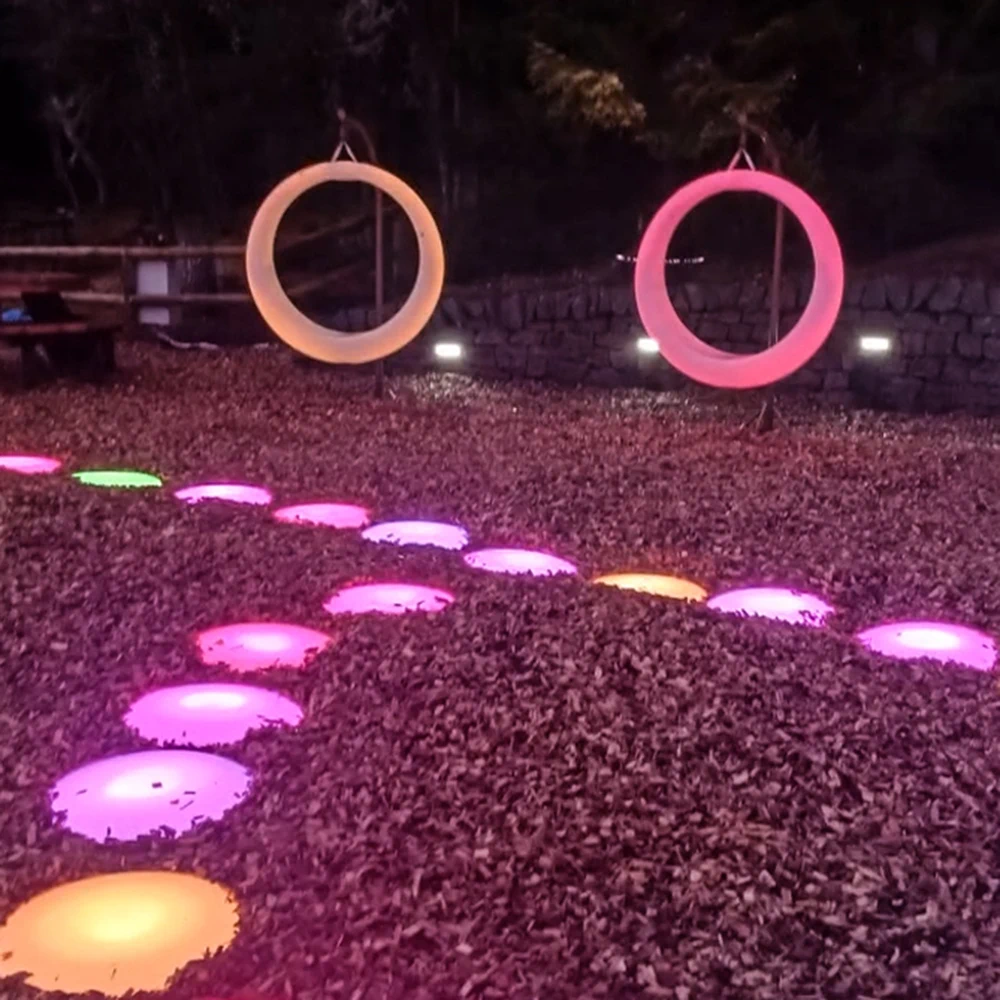 Glowing LED Swings and LED Floor Tiles as Event Lighting Furniture in a Forest Setting
