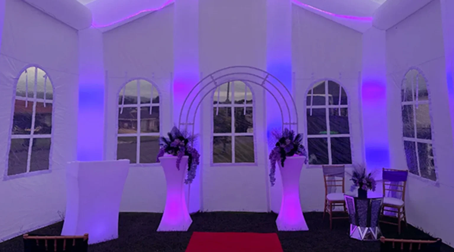 Inside an Inflatable Wedding Venue with Purple Lighting and Wedding Event Furniture