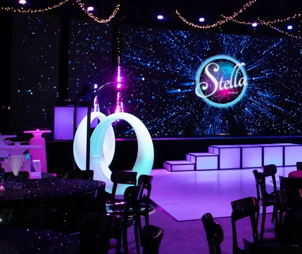 The suspended luminous rings emit a soft white light in the dark space, adding a surreal, sci-fi aesthetic to the dopamine-infused indoor atmosphere.11