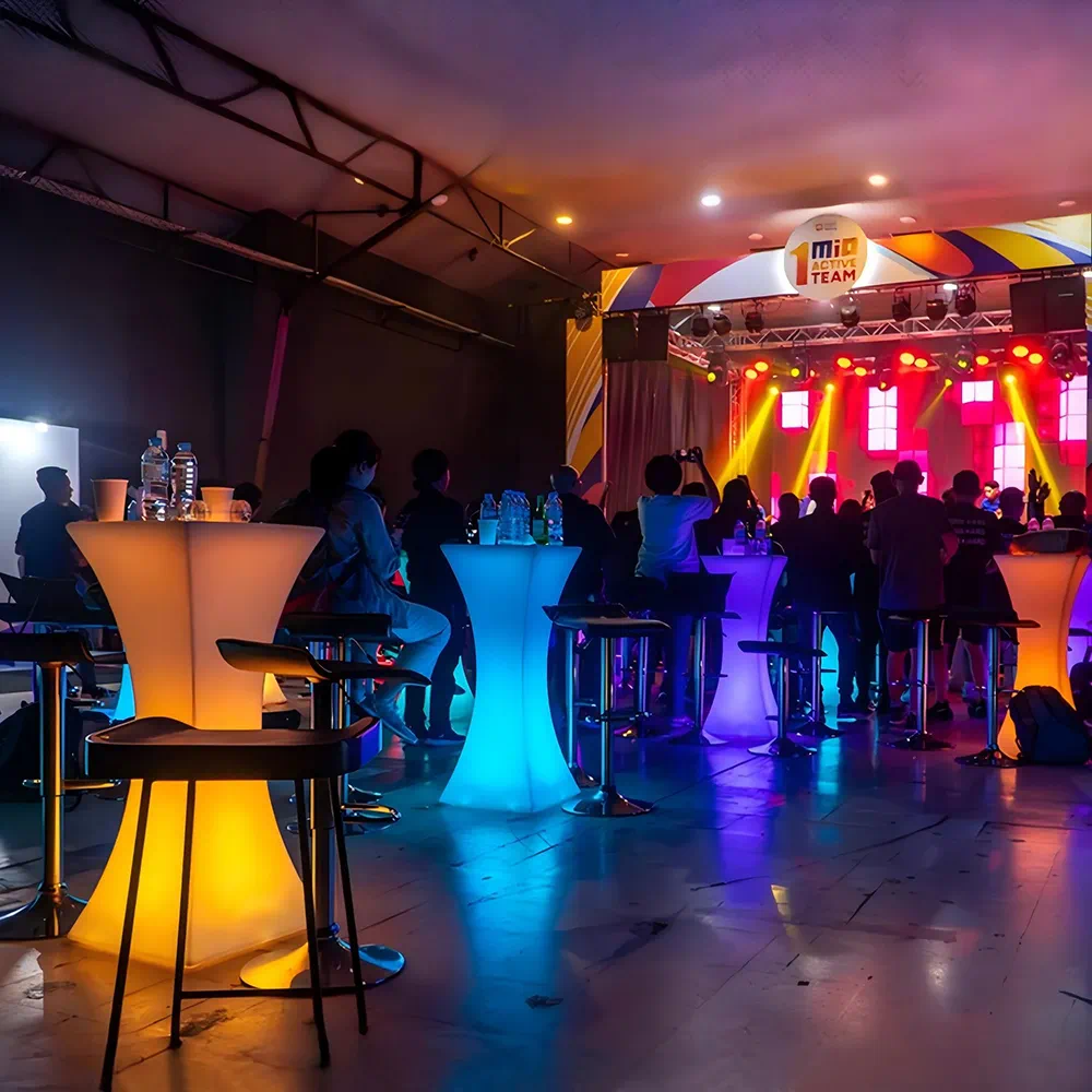 Vibrant Indoor Event with LED Event Decor Furniture, Glowing Hourglass Bar Tables, Colorful Lighting, and Dynamic Stage