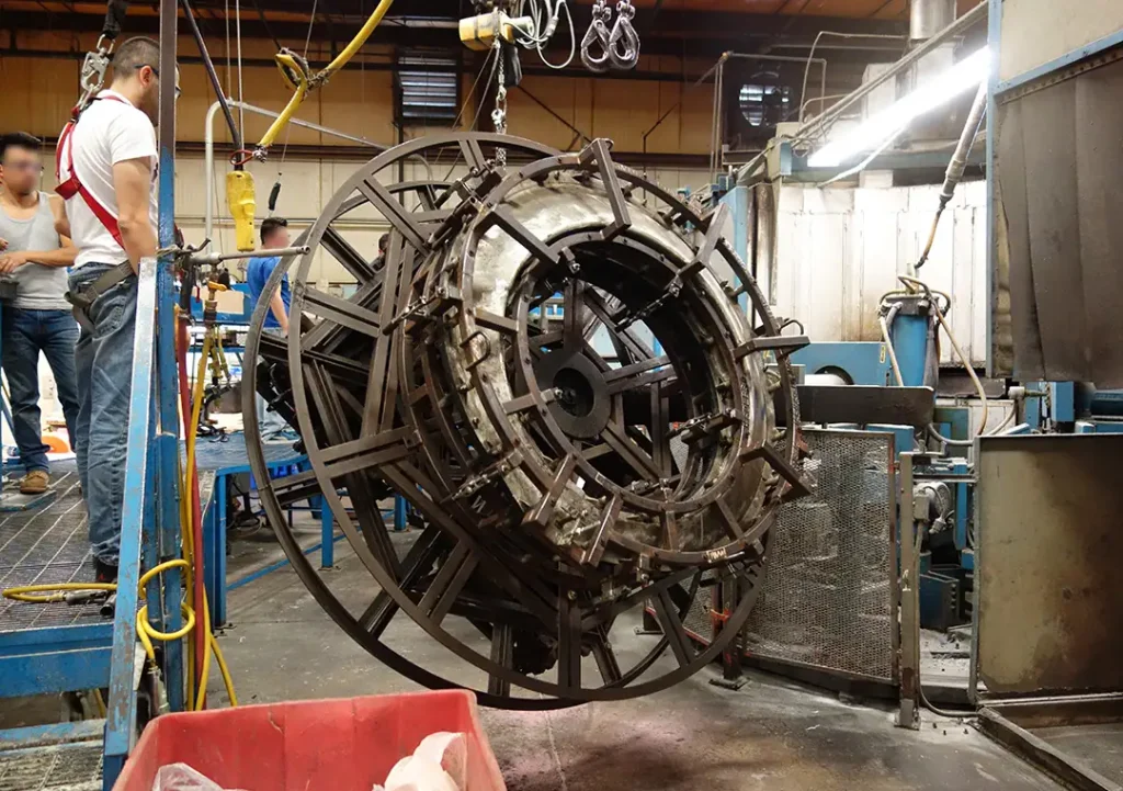 Circular steel framework for Rotational Molding Mold Design in an industrial facility.