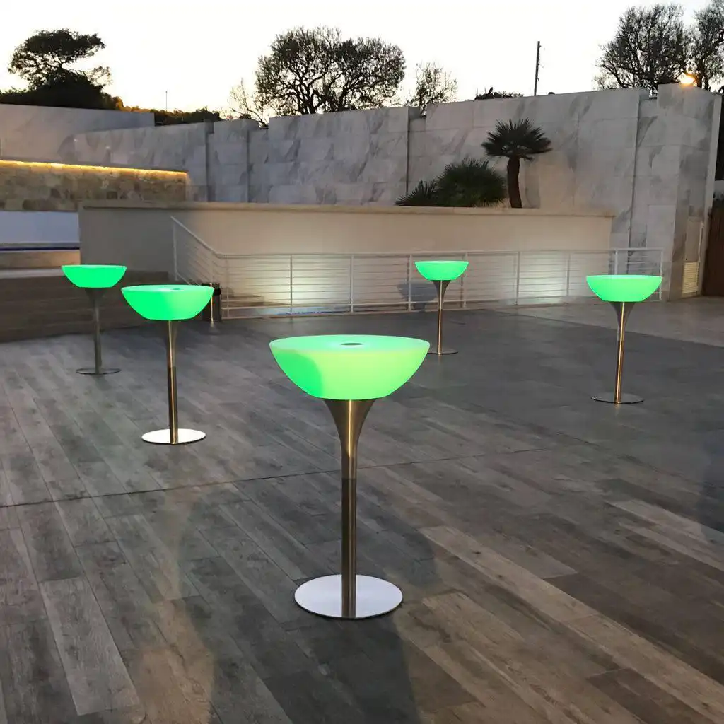 Glow bar tables and led lighted furniture in a modern patio setting.