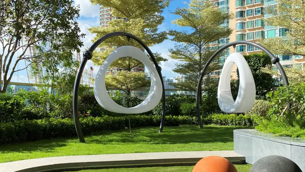White Circular Swing Chairs in a Hong Kong park.