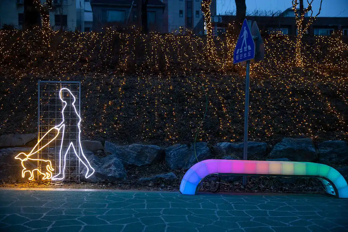 A functional, sit-on Bench With Light (light-up bench) with rainbow LED illumination, suitable for outdoor park use.