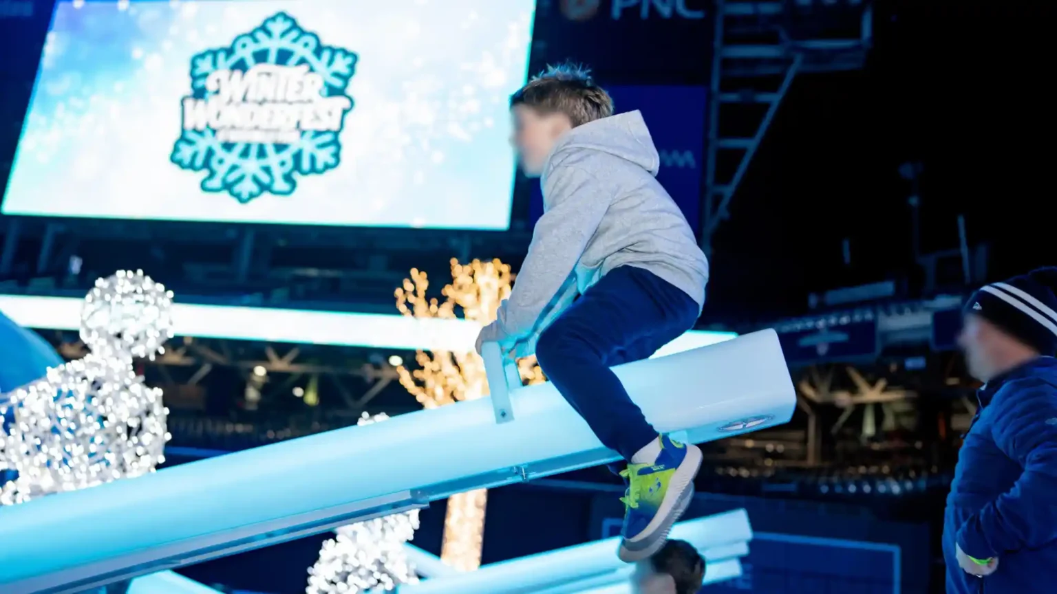 Boy-playing-on-a-glowing-seesaw-at-the-Winter-Wonderfest-light-up-games-event-in-Nationals-Park