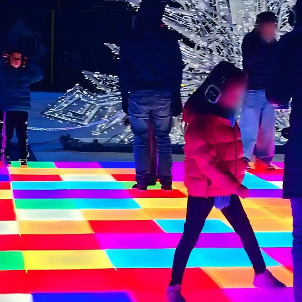 Children-dancing-on-a-vibrant-multicolor-LED-dance-floor-for-light-up-games-at-a-night-event
