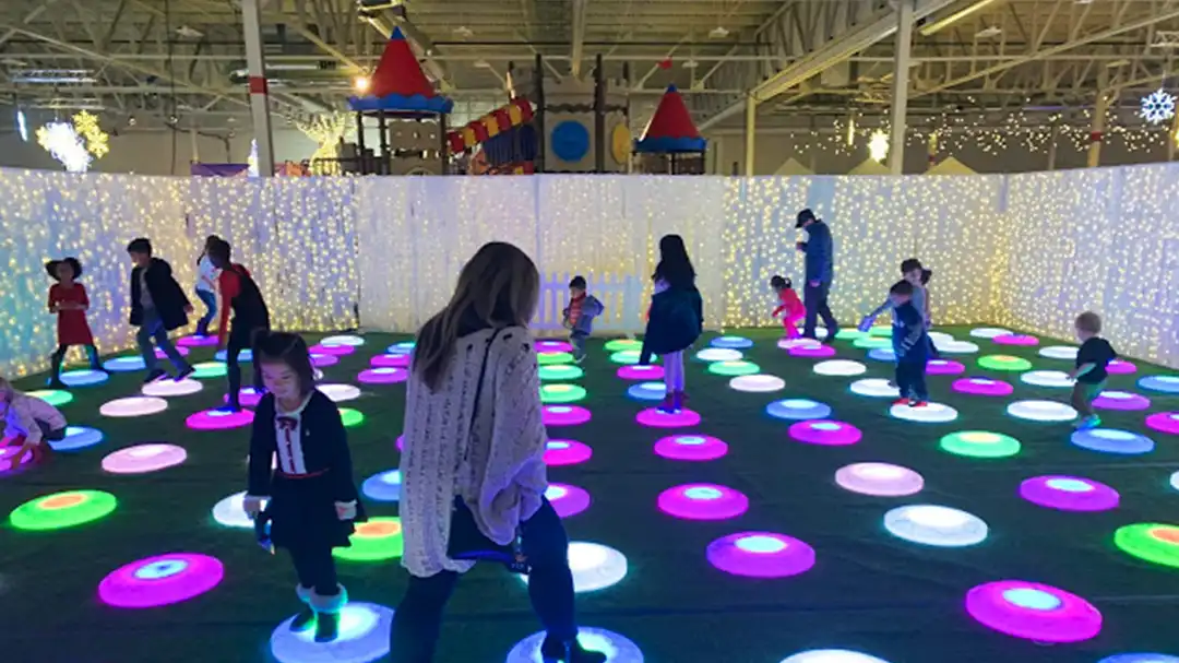 Interactive LED Glow Furniture featuring round illuminated floor tiles for a children's indoor play area.