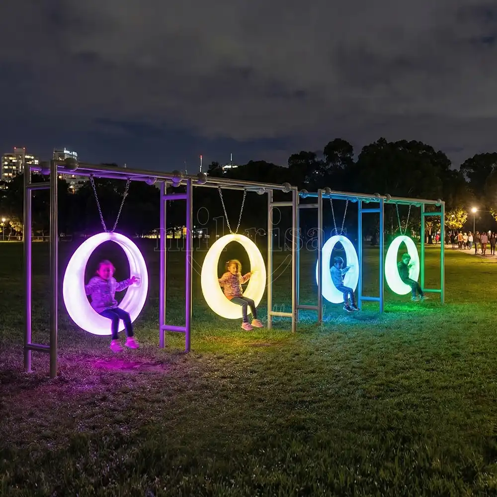 Interactive Outdoor Round Swing glowing in the dynamic park night, from an LED playground furniture manufacturer.