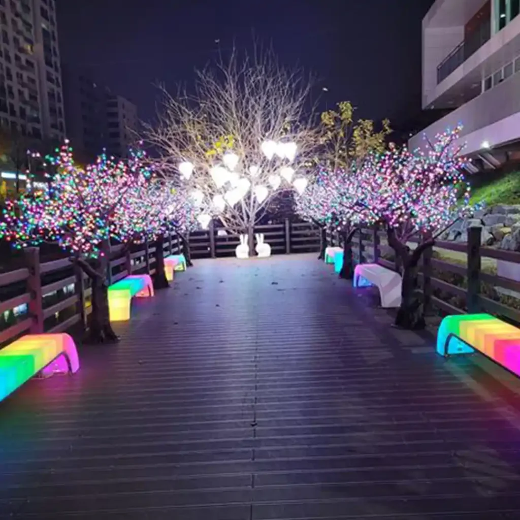 Modern functional LED Bench With Light glowing in front of a starry neon wall at night.