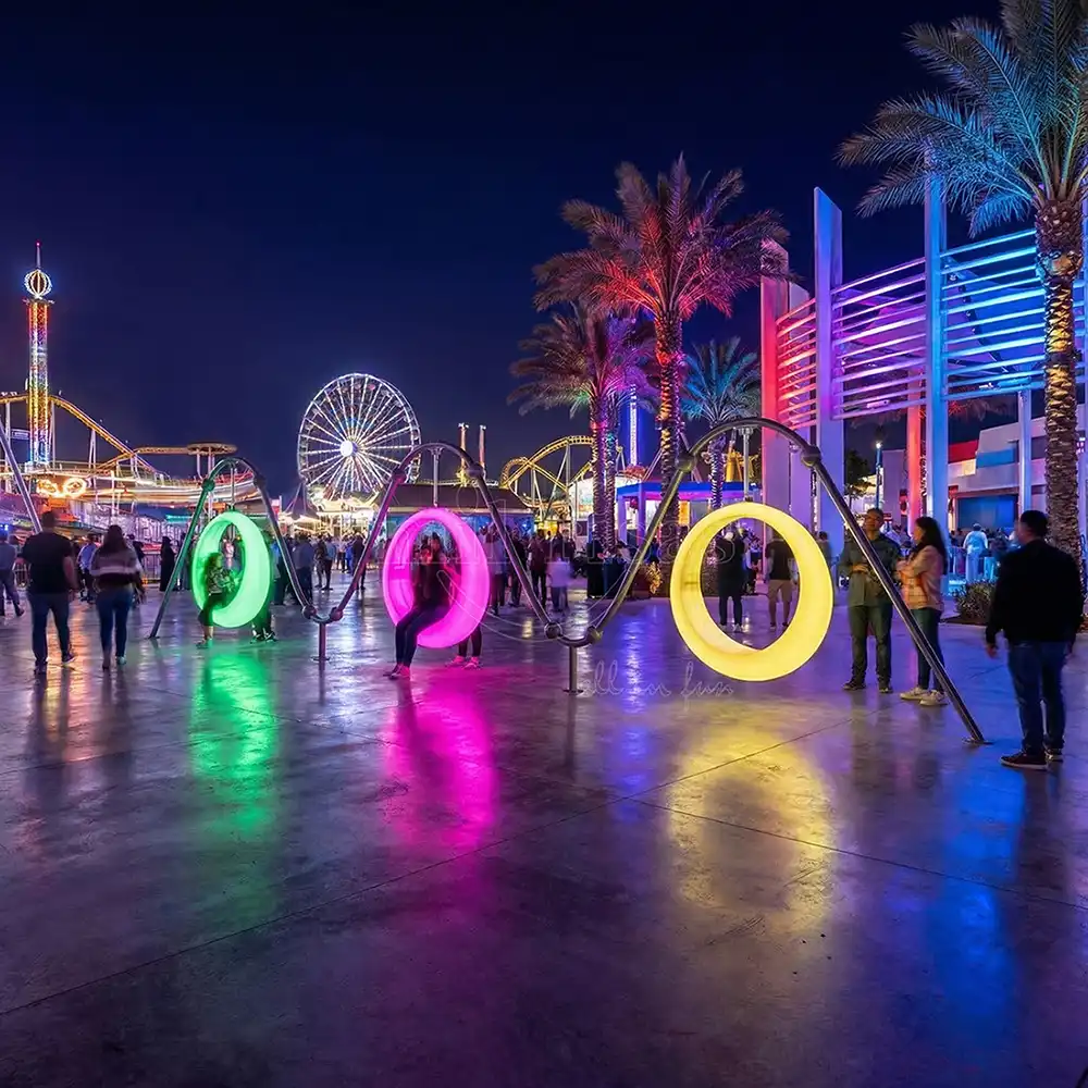 Three vibrant circle swings with green, pink, and yellow lights installed at an amusement park at night