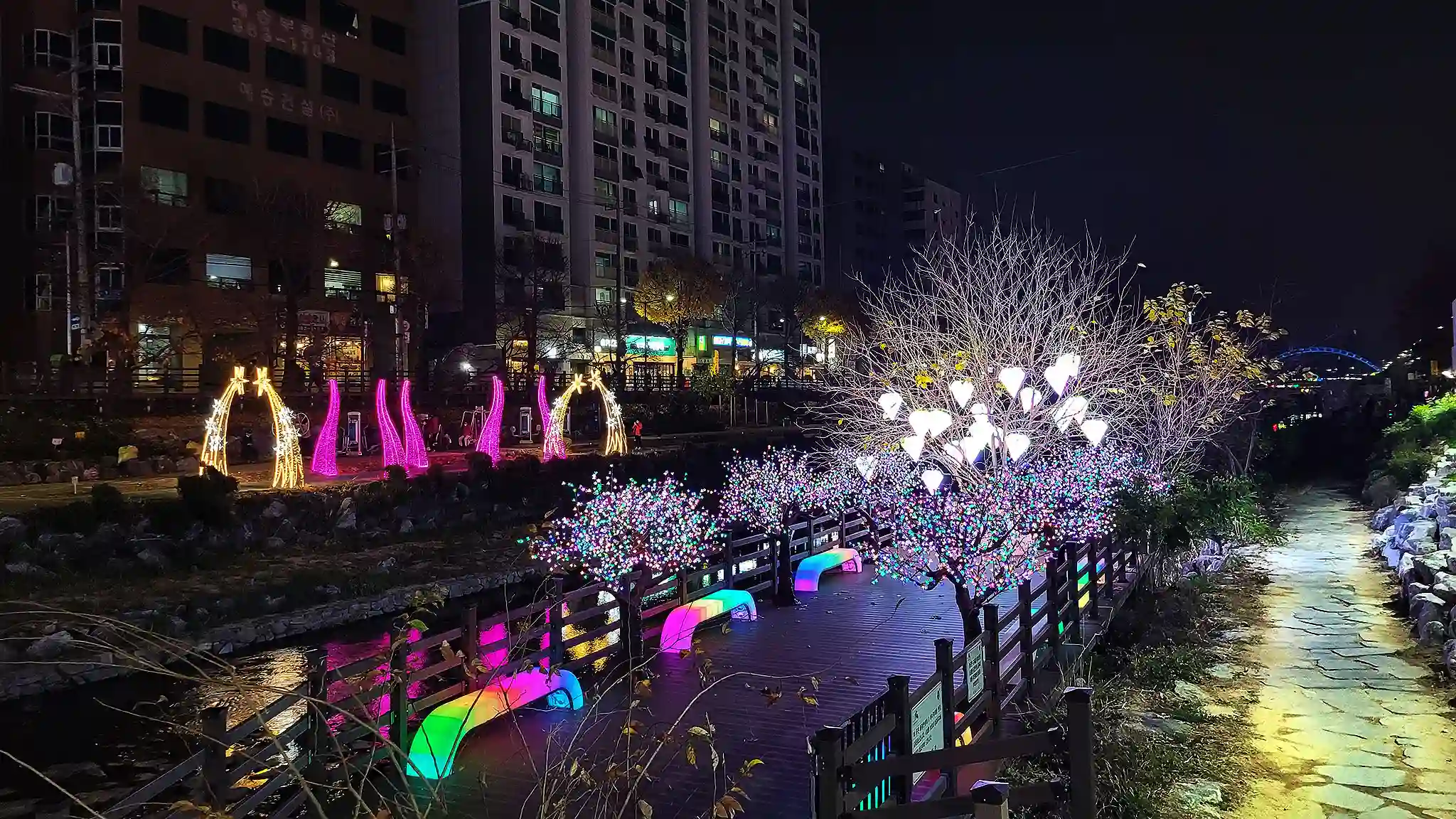 Vibrant multi-color Bench With Light illuminating an outdoor pedestrian path