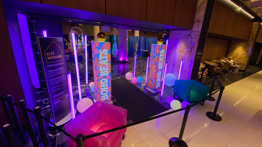 A colorful shopping mall entrance in Quebec featuring various sized LEDballs and glowing furniture for an illuminated games brand event