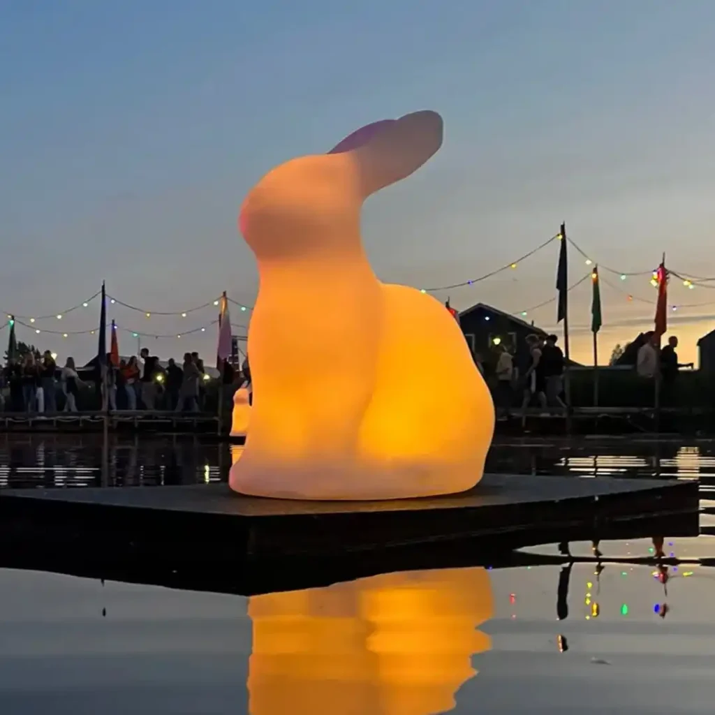 Festival Glowing Rabbit art installation floating on water, providing interactive furniture led lighting for Simmerdeis Festival.