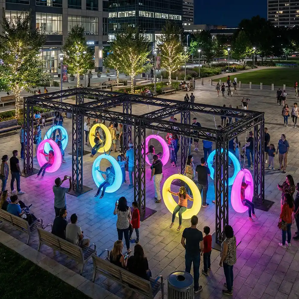 LED Furniture Manufacturer Glowing Outdoor Circle Swing with people at a commercial plaza night