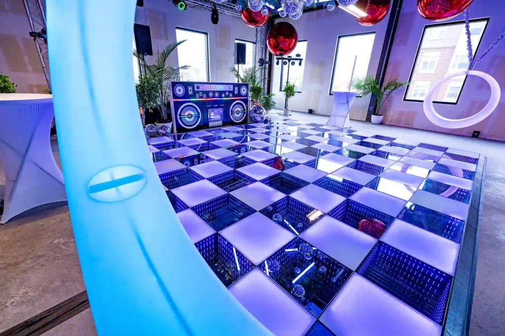 Layout of a Colorado event venue captured through a blue swing glow, featuring an interactive DJ dance floor and retro disco decorations