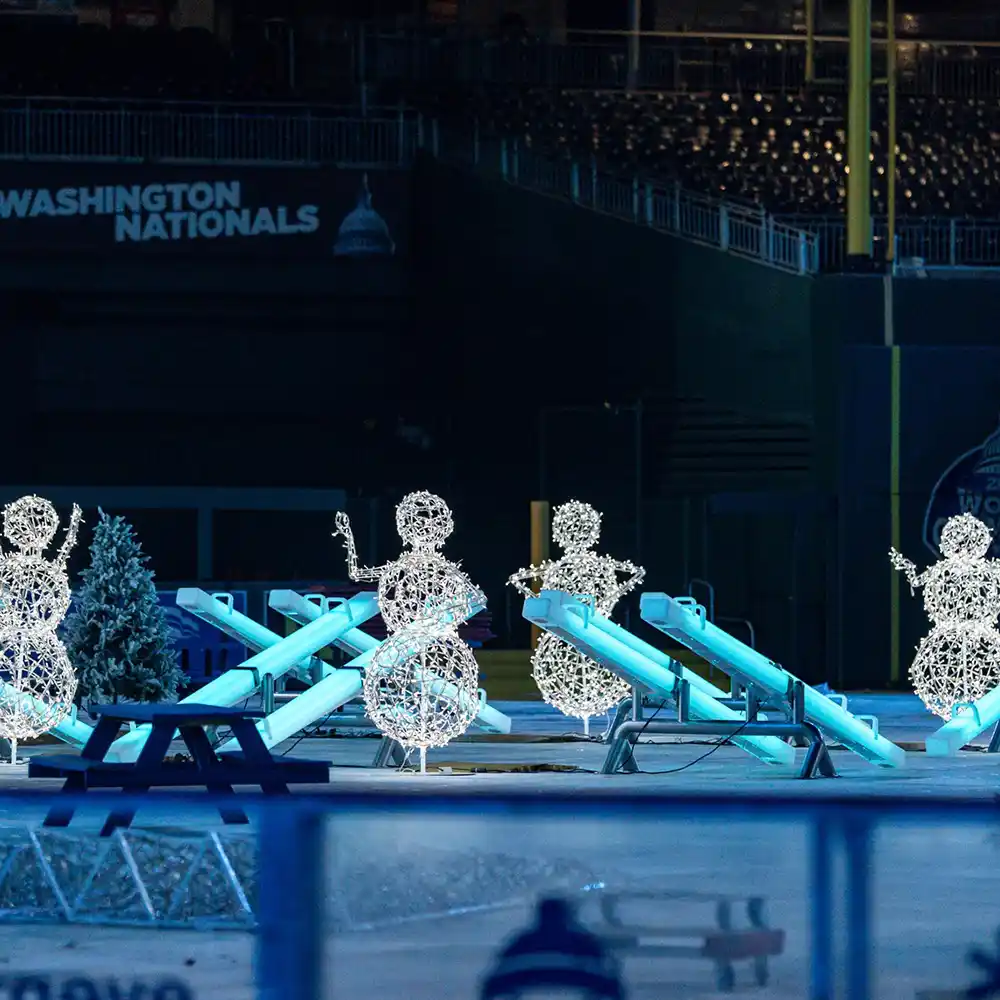 Commercial grade light up games seesaws installed at a stadium for winter festival events